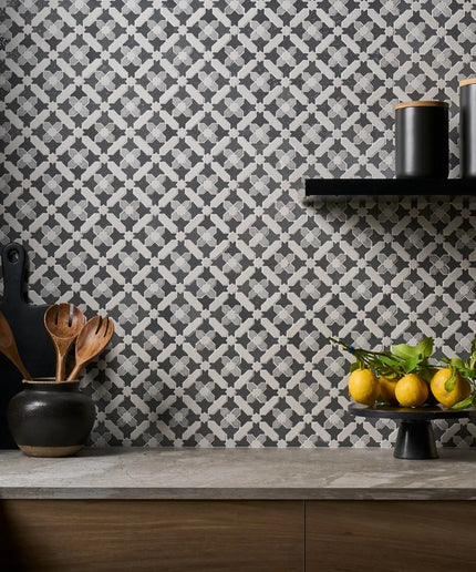 Kitchen counter with decorative elements against a patterned wall.