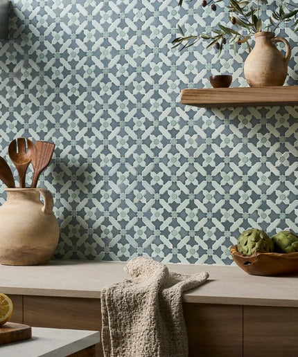 Kitchen with patterned wallpaper, wooden shelves, and decorative items.