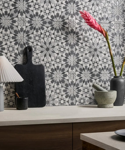 Decorative kitchen scene with patterned tiles, lamps, and vases.