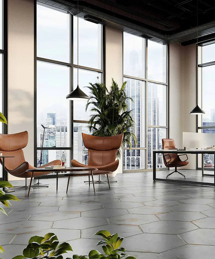 Modern office space with large windows, chairs, and a desk.