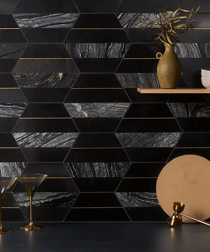 Hexagonal black marble tiles with gold grout in a geometric pattern, with decorative items on a shelf.