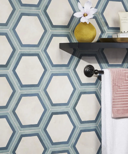 Hexagonal patterned tiles in a bathroom setting with a shelf and decorative items.