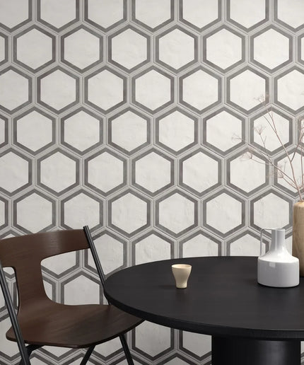 Hexagonal patterned wall with a table and chairs in the foreground