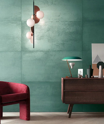 Modern interior with a green wall, red armchair, and wooden sideboard.