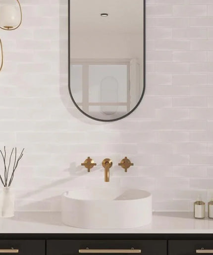 Modern bathroom with a sink, mirror, and decorative elements.