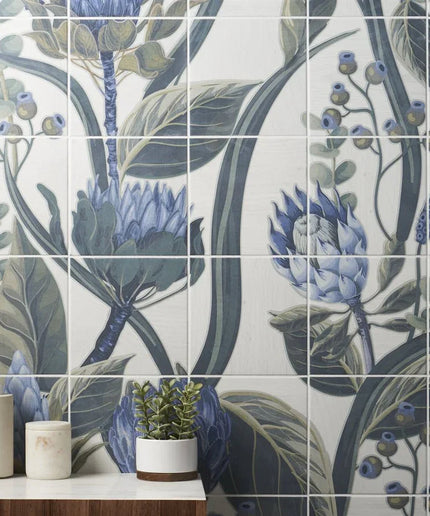 Bathroom with floral tile design featuring blue flowers and green leaves.