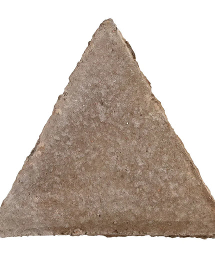 Triangular stone tool on a white background