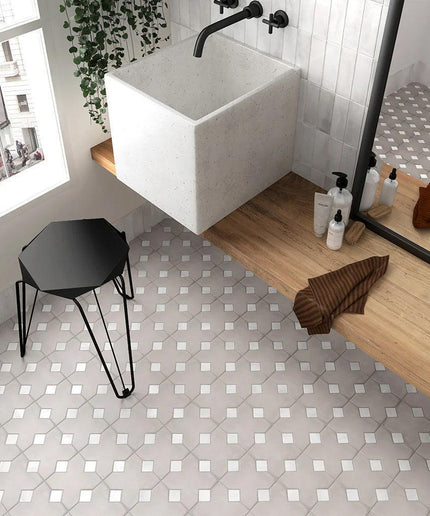 Bathroom with a white sink, wooden bench, and patterned floor.