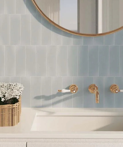Bathroom with tiled wall, sink, and decorative elements