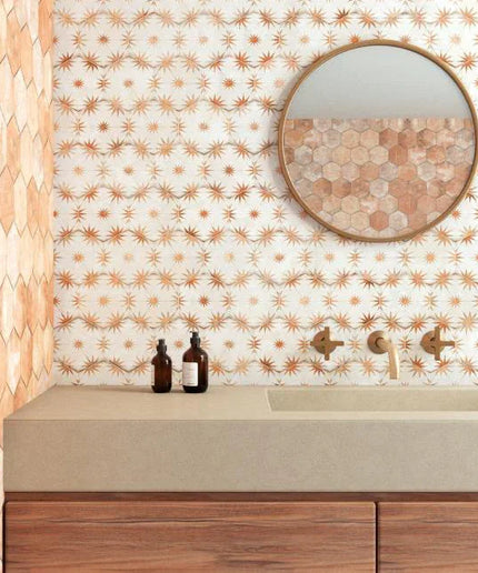 Bathroom vanity with decorative wall tiles and a round mirror.