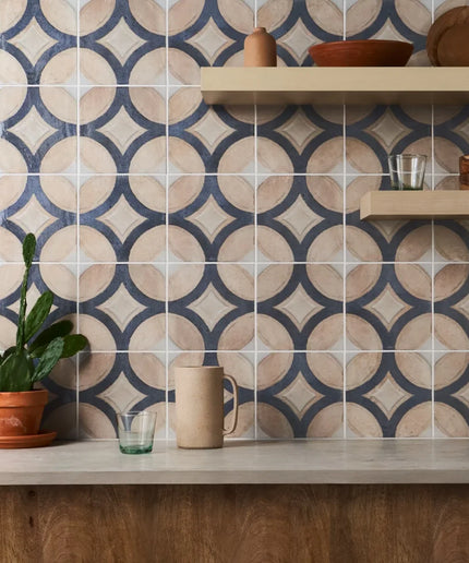 Kitchen with patterned tiles on the wall and wooden shelves.