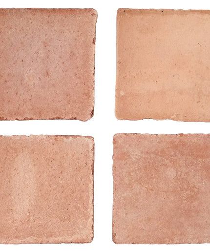 Four square tiles with a terracotta color on a white background