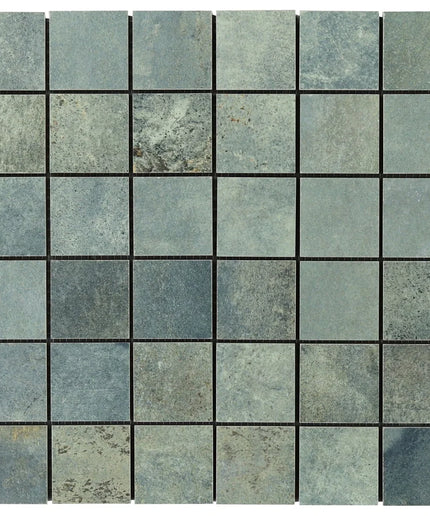 Mosaic pattern of square tiles in various shades of blue and gray.