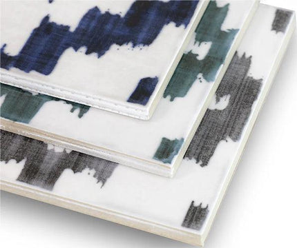 Set of ceramic coasters with abstract blue, green, and black design on a white background
