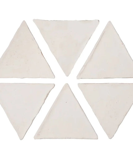 Set of six triangular white tiles on a white background