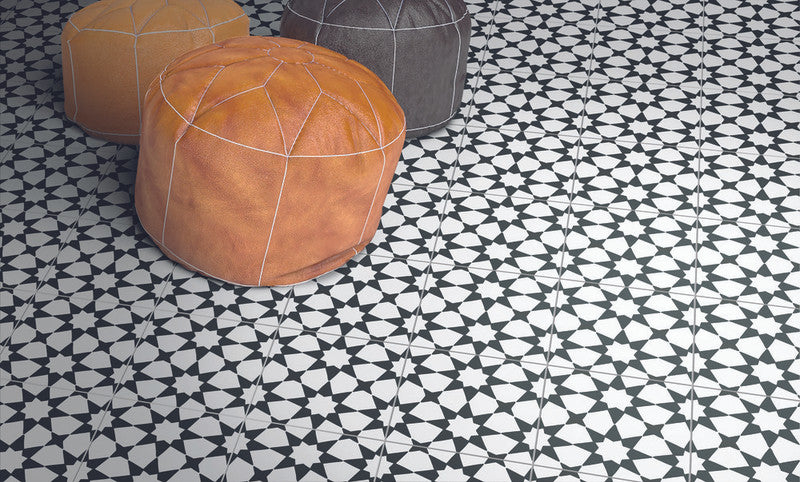 Black and white harlequin diamond pattern floor tiles in a luxury entryway.