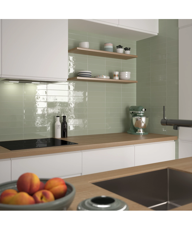 Modern kitchen with glossy green backsplash tiles, wooden countertop, and open shelves
