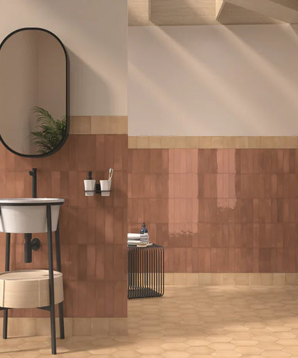 Bathroom interior with tiled walls, a sink, and a mirror.