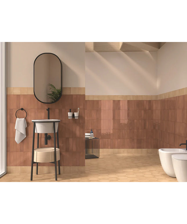 Bathroom interior with tiled walls, a sink, and a mirror.