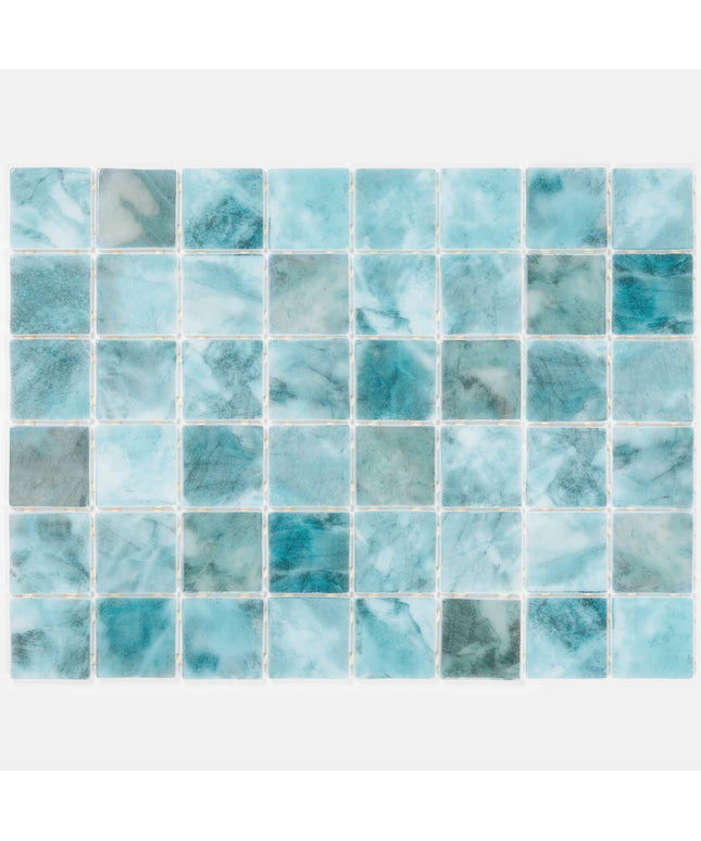 Mosaic pattern of blue and green tiles on a white background