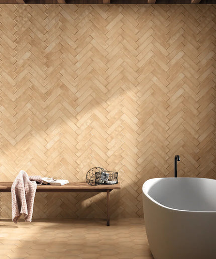 Bathroom with wooden wall and floor, white bathtub, and wooden bench.