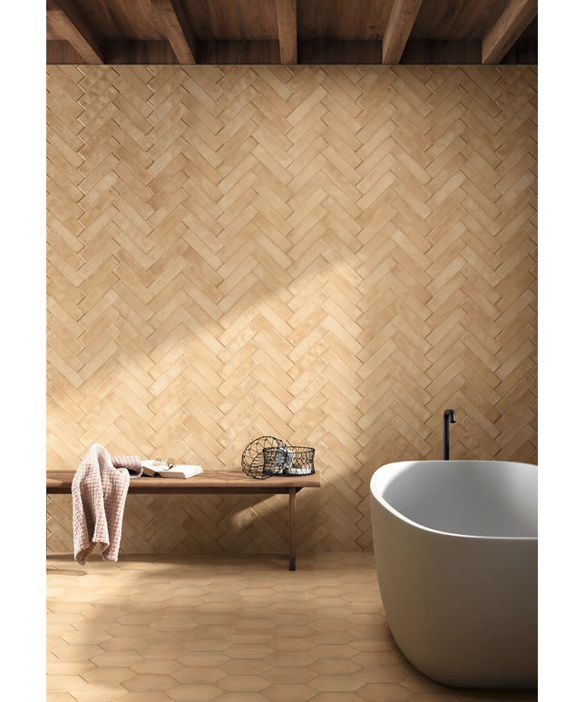 Bathroom with wooden wall and floor, white bathtub, and wooden bench.