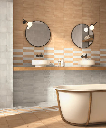 Modern bathroom with a bathtub, sinks, and decorative elements.