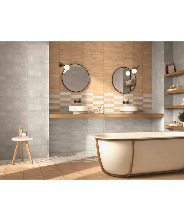Modern bathroom with a bathtub, sinks, and decorative elements.