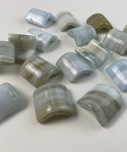 Curved glass mosaic tiles in soft blue and beige tones for backsplash or shower decor