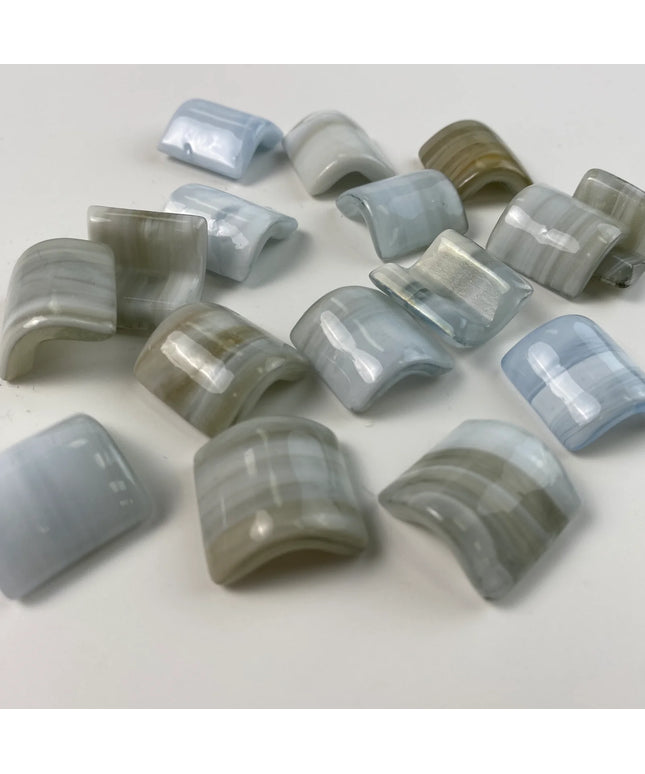 Curved glass mosaic tiles in soft blue and beige tones for backsplash or shower decor