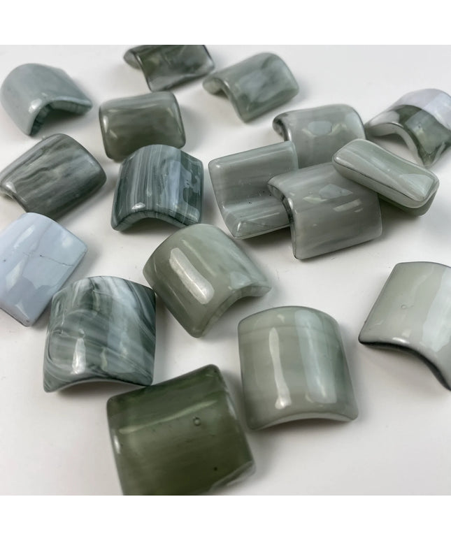 Curved, glossy green mosaic glass tiles for kitchen backsplash or bathroom decor.