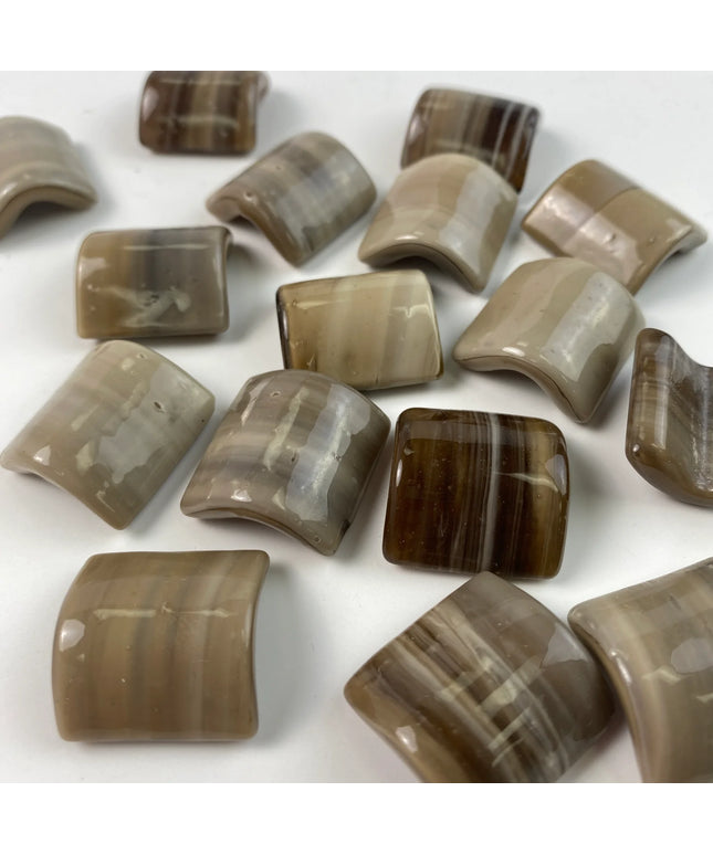 Glossy rectangular and square mosaic tiles in beige and brown tones on a white background