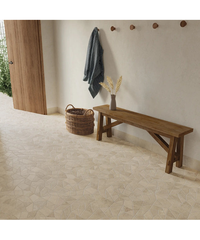 Wooden bench and hooks against a wall with a textured floor.