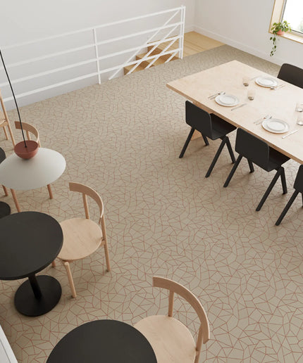 Modern dining area with tables, chairs, and a patterned floor.