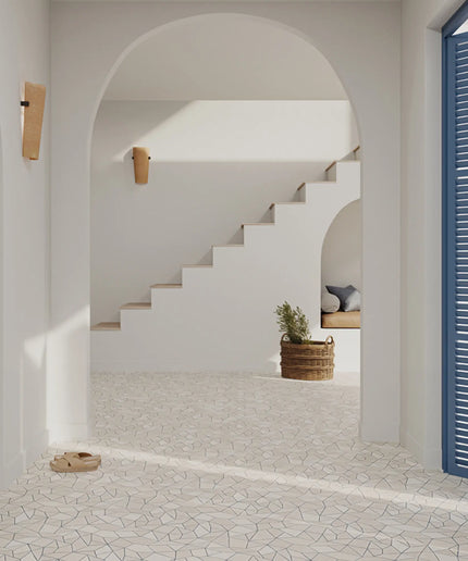 Staircase in a modern interior with white walls and a blue door.