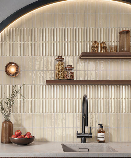 Almond mix vertical kitchen backsplash tiles with modern faucet, shelves, and countertop decor
