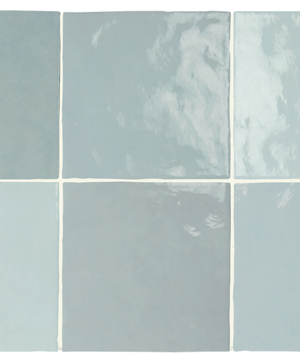Six square ceramic tiles arranged in a 2x3 grid, showcasing different glaze finishes and colors in a dusty light blue, sage green, and pale gray-blue palette.