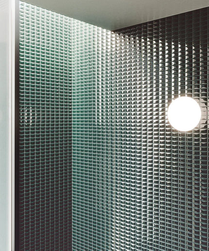 Bevel_Emerald_Gloss-bath Green perforated metal panel with a light fixture on a ceiling