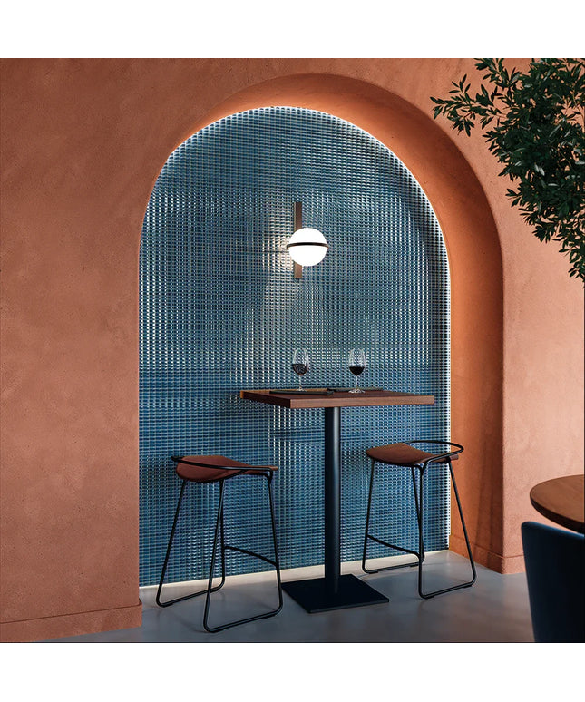 Bevel_Saphire_Gloss-walls Modern interior with pink walls, a blue tiled wall, and a small table with two chairs.