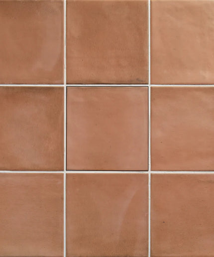 Grid of terracotta tiles with a warm brown color.