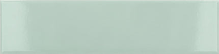 A glossy rectangular ceramic tile in a pale mint green color, shown from a top-down perspective with a subtle sheen.