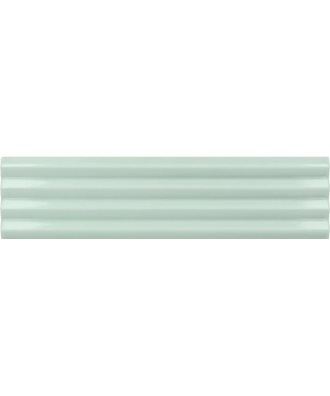 A close-up of a glossy, pale mint green ceramic tile with horizontal grooves.