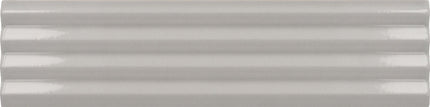 A close-up of a glossy, light gray ceramic tile with a subtle horizontal ribbed texture.