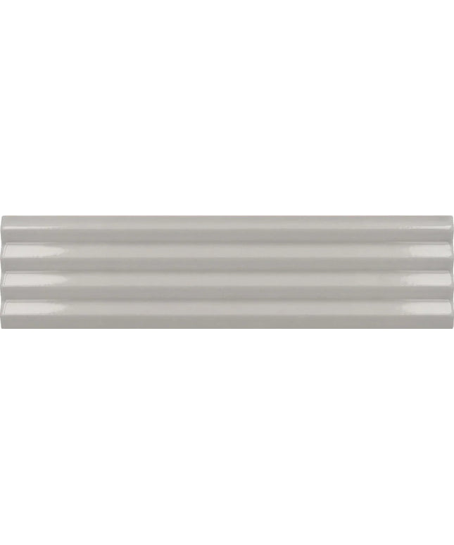 A close-up of a glossy, light gray ceramic tile with a subtle horizontal ribbed texture.