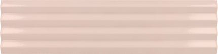 A close-up of a glossy, horizontally grooved ceramic tile in a light blush pink color.
