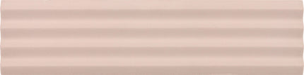 A close-up of a smooth, pale blush pink surface with subtle horizontal ridges.
