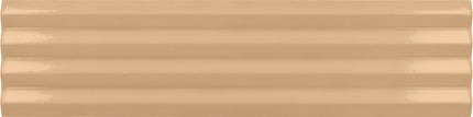A close-up of a glossy, ribbed beige surface, likely a ceramic or porcelain tile, showing horizontal grooves and a warm sandy color.