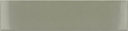 A rectangular glossy ceramic subway tile in a muted sage green color, shown flat against a matching background.