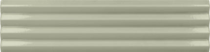 A close-up of a glossy, ribbed ceramic tile in a light sage green color.