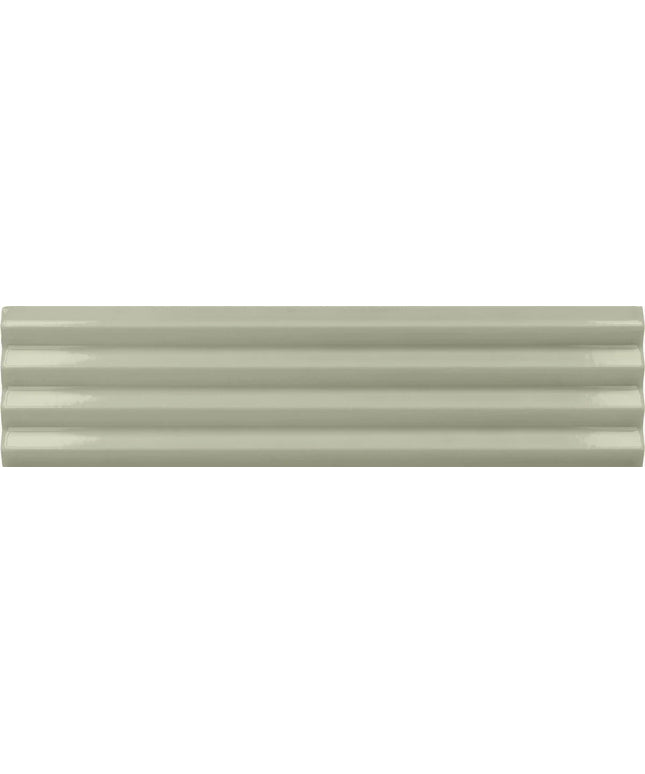 A close-up of a glossy, ribbed ceramic tile in a light sage green color.